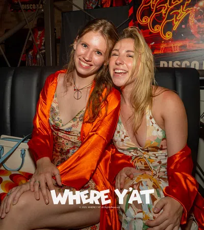 two women sitting on a couch