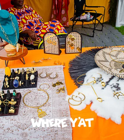 Colorful jewelry display with various earrings, necklaces, and accessories at a vibrant market setting.
