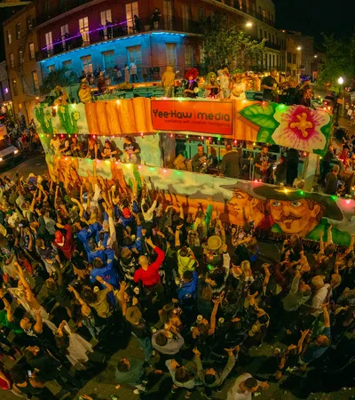 Night parade with vibrant float painted with colorful faces and lively crowd enjoying the festive street event