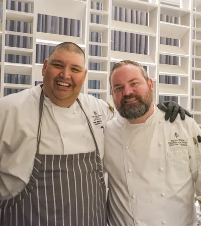 a couple of men smiling