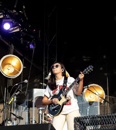 a person playing a guitar on a stage