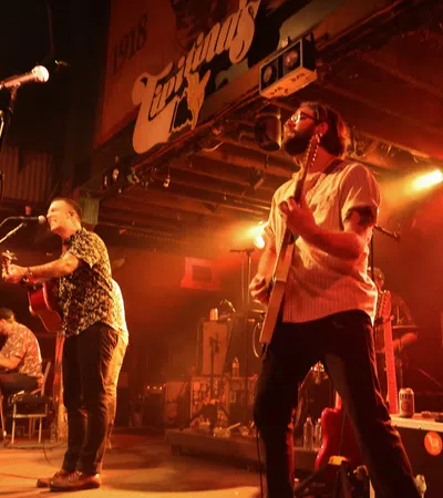 a group of people playing instruments on a stage