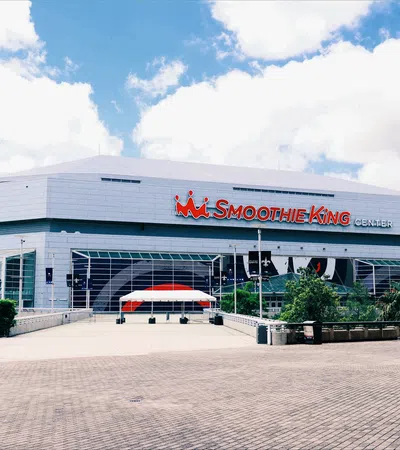 Smoothie King Center arena with signage and clear sky in New Orleans, Louisiana