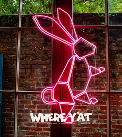 a red metal sculpture on a brick wall