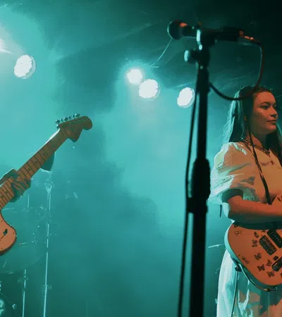 a couple of women playing guitars