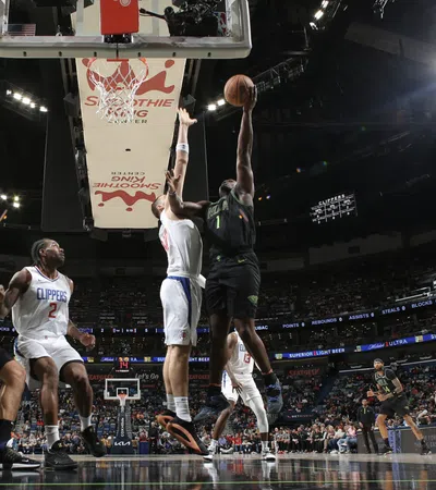a basketball player jumping to dunk a basketball