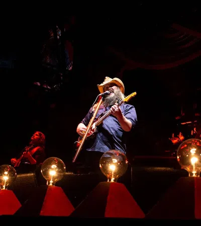 a person playing a guitar on a stage
