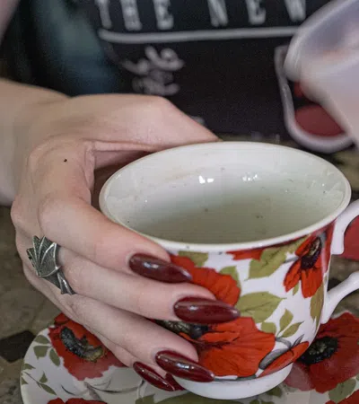 a person holding a cup of tea
