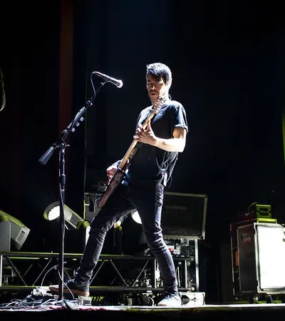 a man playing a guitar on a stage