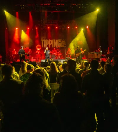 a crowd of people watching a band on a stage