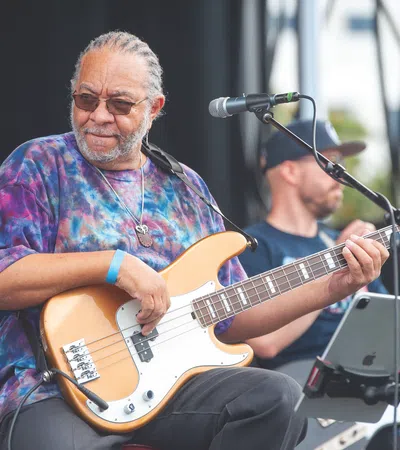 George Porter, Jr. playing a guitar