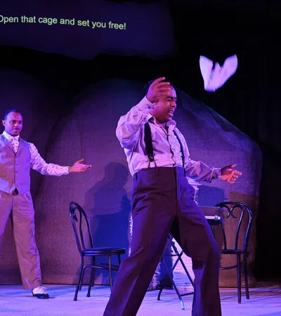 a couple of men dancing on a stage
