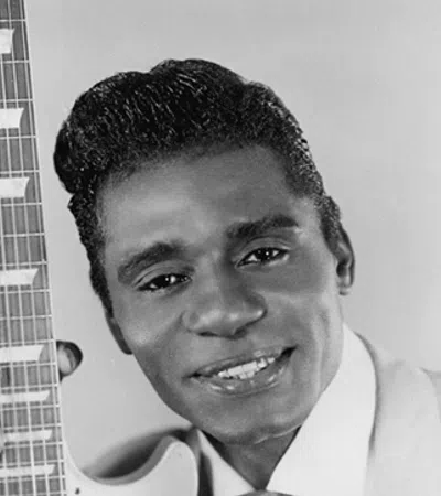 Guitar Slim smiling and holding a piece of paper