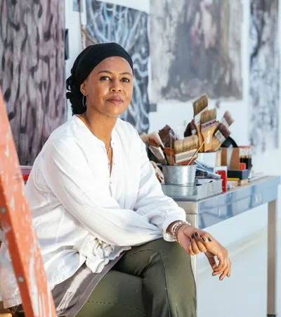 Wangechi Mutu sitting on a chair