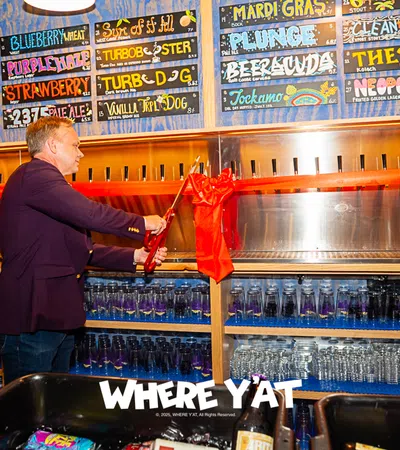 a person standing in front of a bar with a red cloth from the ceiling
