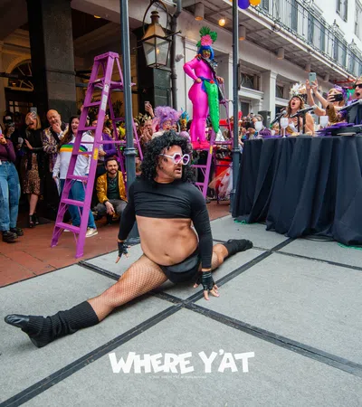 a person sitting on a stage with a crowd watching