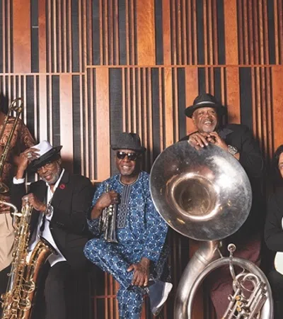 a group of people posing for a photo with instruments
