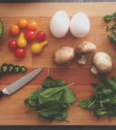 a knife and vegetables on a cutting board