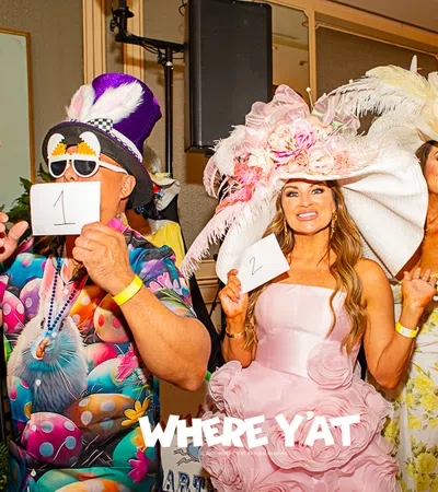 Colorful attendees in extravagant hats at a lively event, showcasing vibrant fashion and fun.