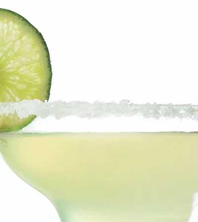 a glass with a lime wedge in it