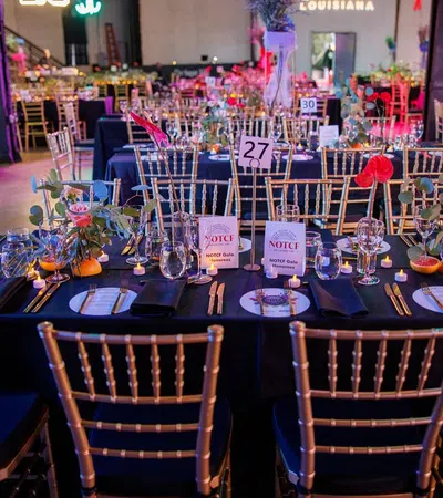 a table with chairs and tables with flowers on it