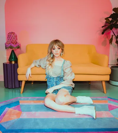 a girl sitting on a rug