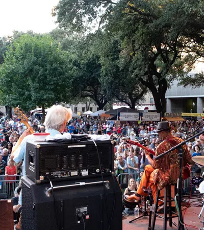 a band playing on stage in front of a crowd
