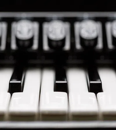 Close-up of piano keys showing white and black keys in sharp focus with blurred background.