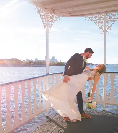 a man and woman kissing on a balcony