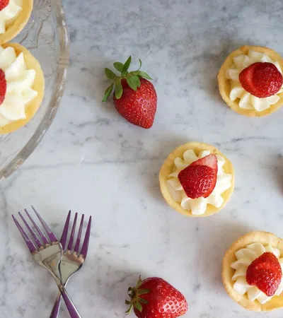 a group of desserts with strawberries and a fork