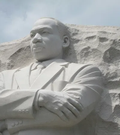 a statue of a man with Martin Luther King Jr. Memorial in the background