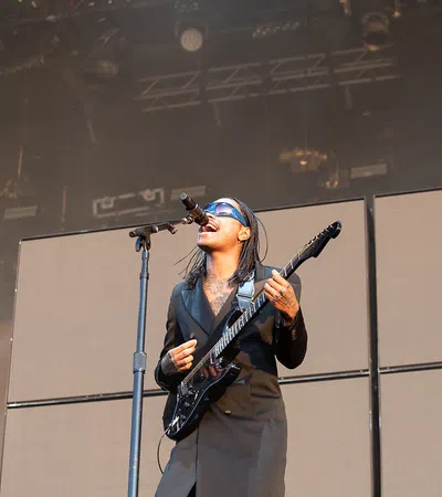 a man playing guitar on stage