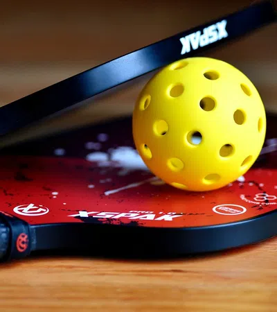 a knife next to a yellow ball