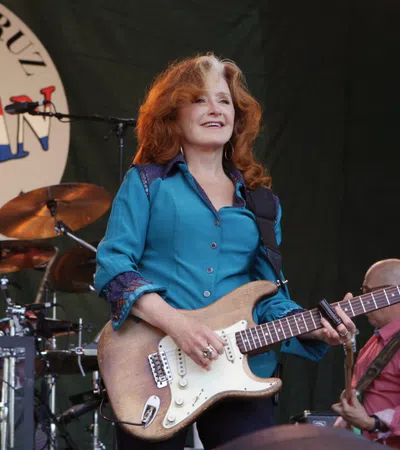 Bonnie Raitt playing a guitar