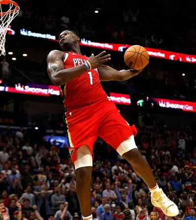 a basketball player jumping to dunk a basketball