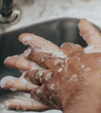 a person washing hands in a sink