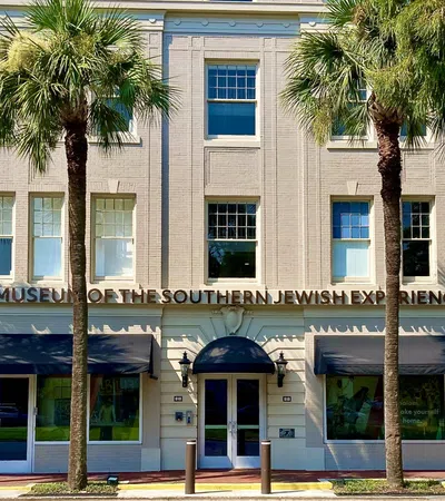 a building with palm trees in front