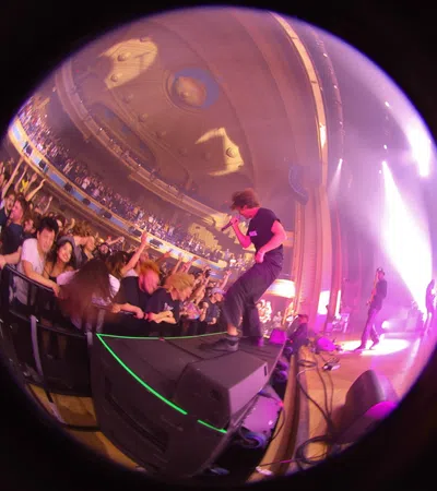 a person on a stage with a crowd watching