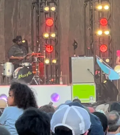 a group of people playing instruments on a stage