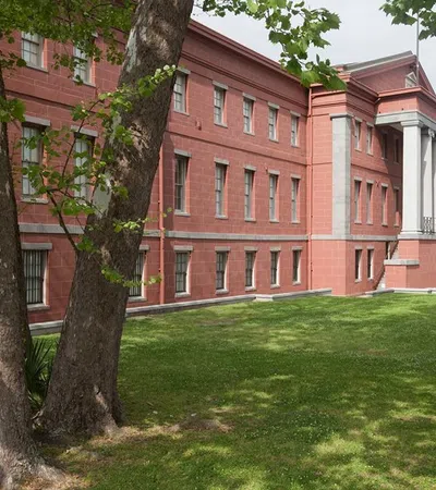 a large red building with trees in front of it