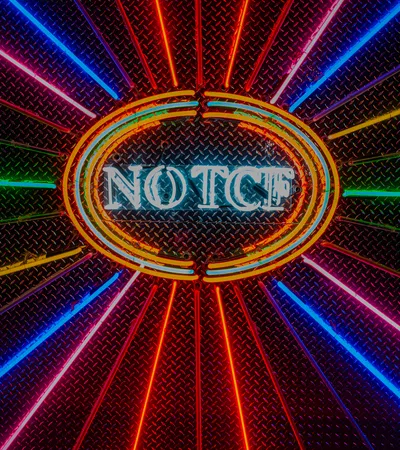 Vibrant neon sign with the word NOTCH encircled by glowing orange rings and radiating colorful light beams.