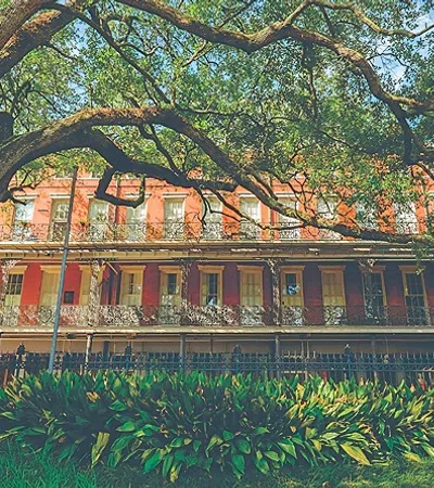 a large house with trees in front of it