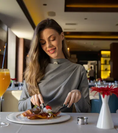 a person eating food at a restaurant