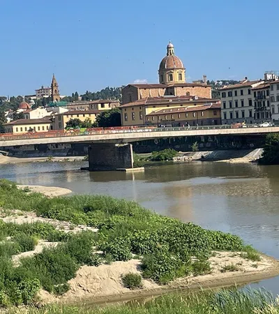 a bridge over a river with buildings in the background