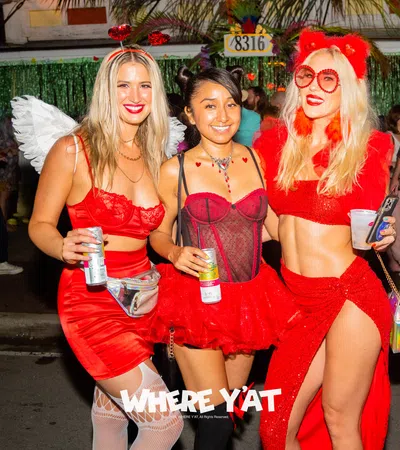 a group of women in red dresses