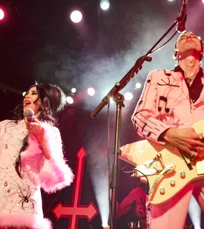 a man and woman playing guitar