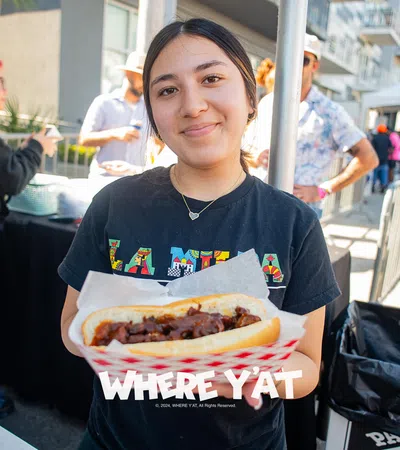 a woman holding a hot dog