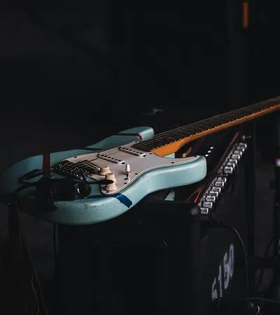 a couple of guitars on a stand