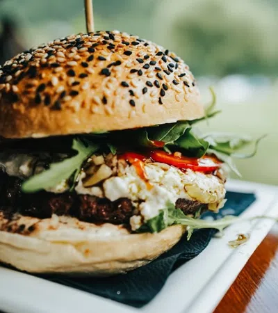 a burger with a side of salad