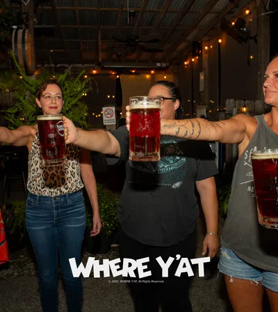 a group of people holding glasses of beer